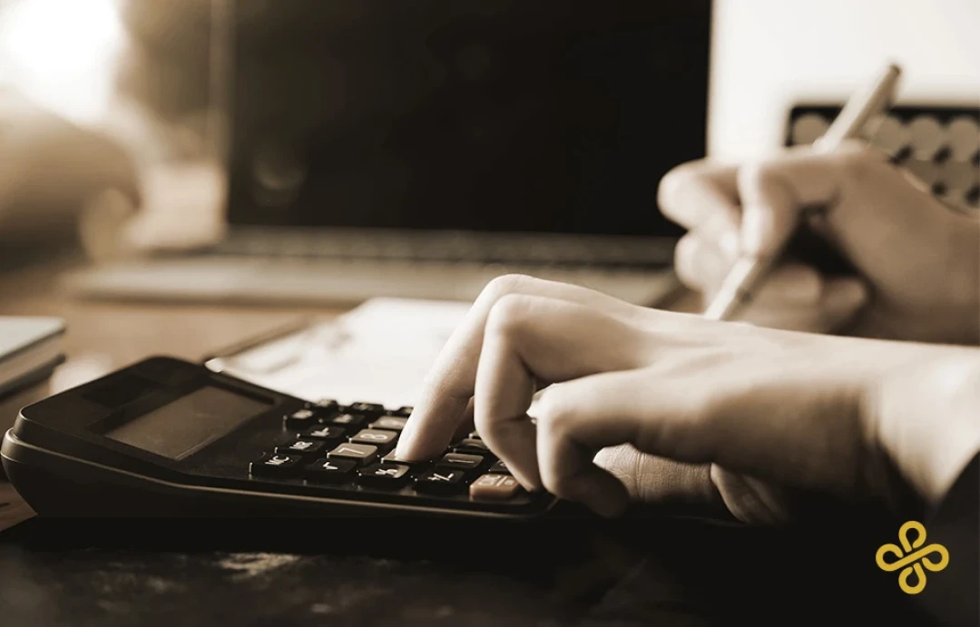 A close up shot of a hand using a calculator