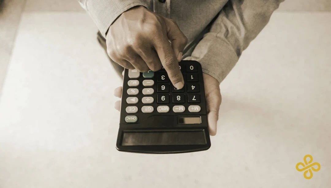 A hand using a calculator