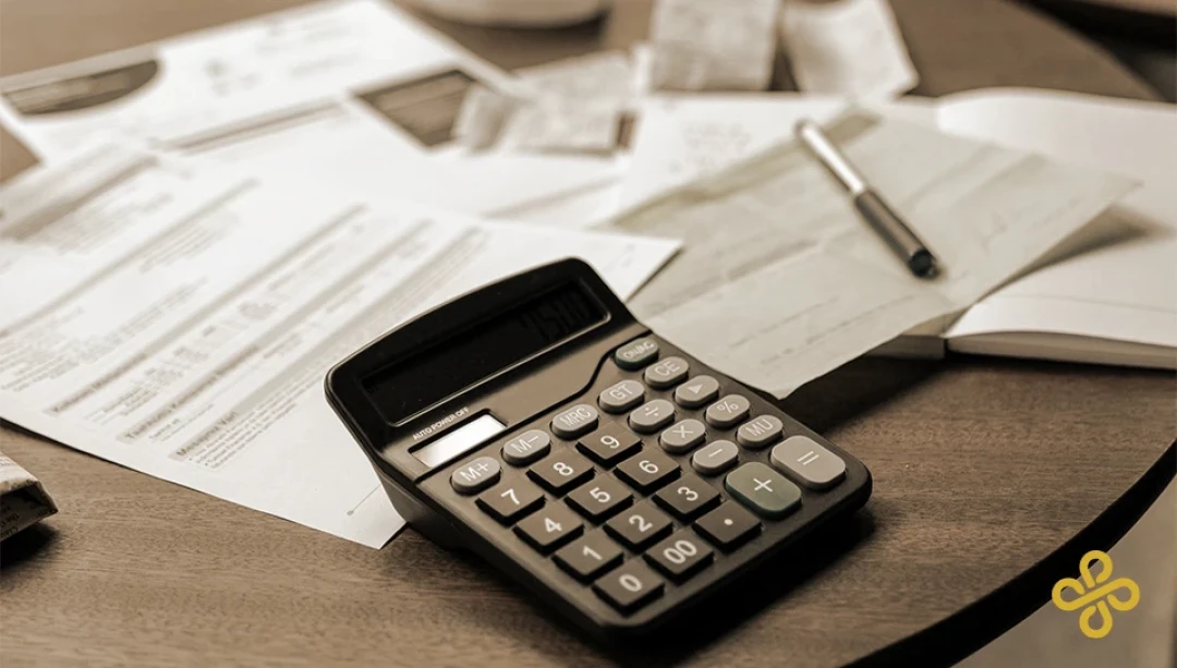 Finance paperwork and calculator on a desk
